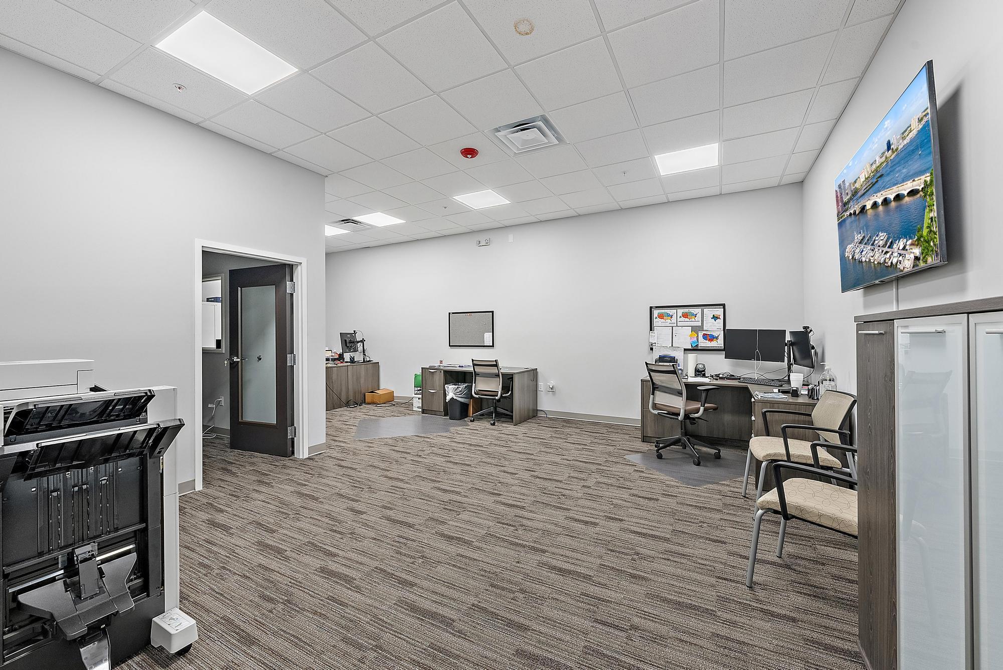3126 Jupiter Park Drive Jupiter, FL 33458 - Photo 17 of 34 a living room with furniture and a flat screen tv