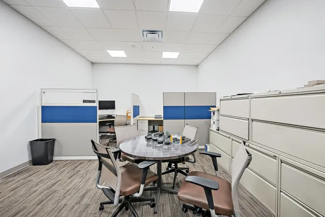 a view of a street with a house in the background
