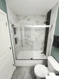 a bathroom with a toilet and a shower