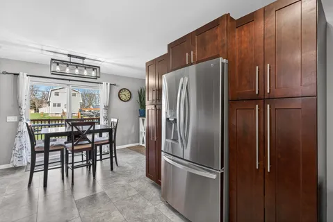 a kitchen with stainless steel appliances granite countertop a refrigerator and a stove top oven