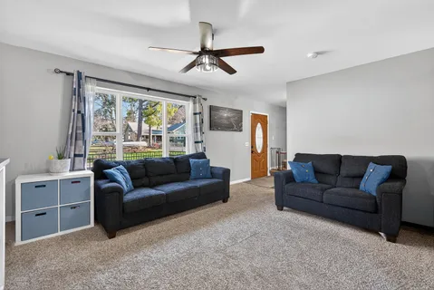 a living room with furniture and a large window
