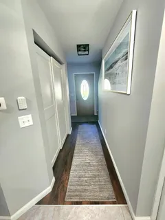 a view of a hallway with wooden floor