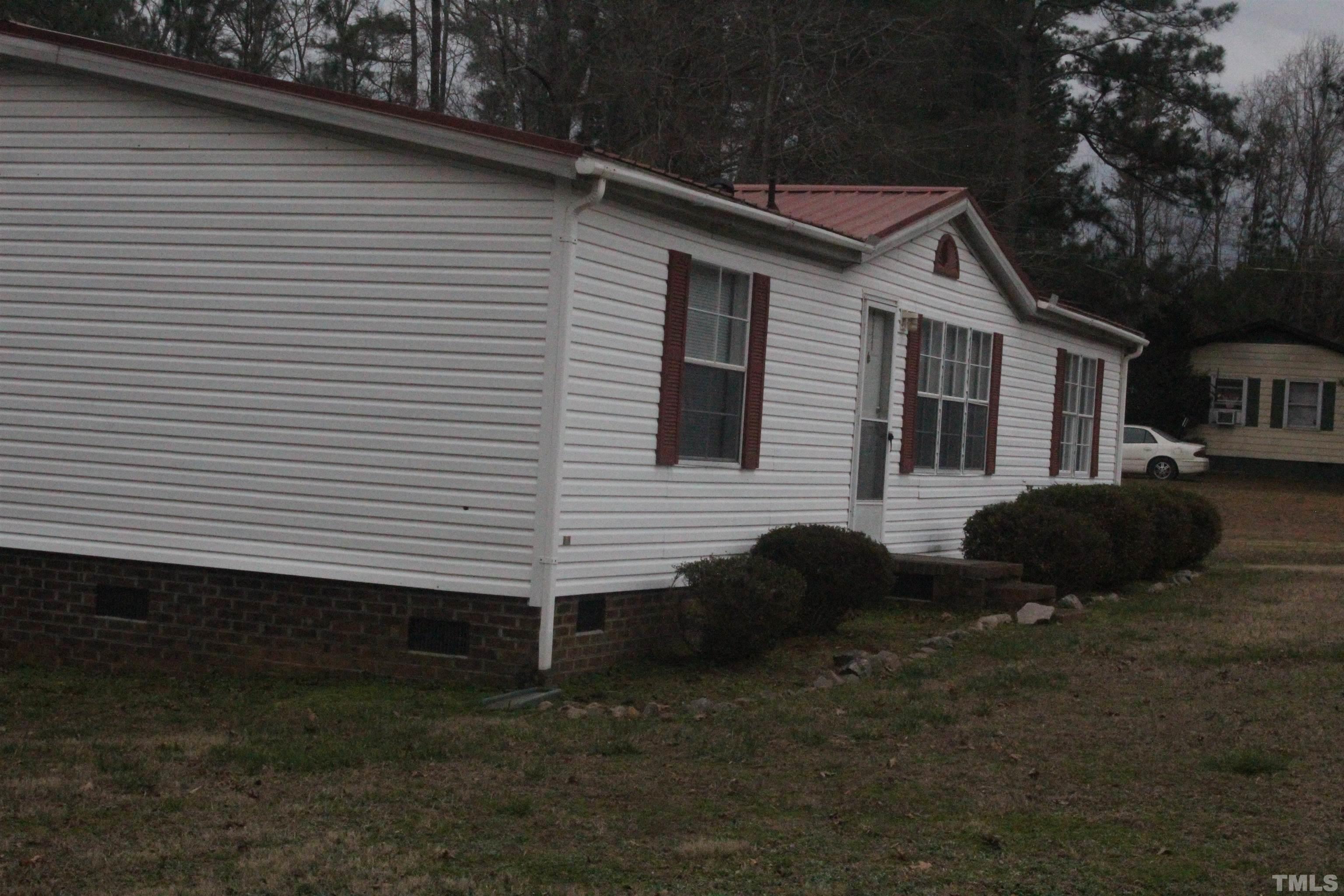 2986 Thomas Road Henderson, NC 27537 - Photo 3 of 21 a front view of a house with a yard