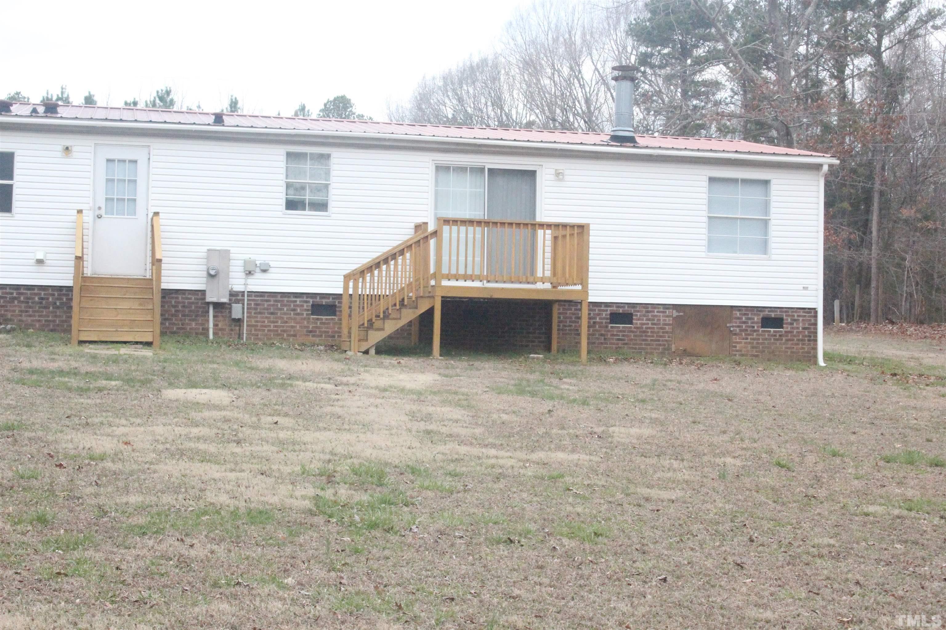 2986 Thomas Road Henderson, NC 27537 - Photo 5 of 21 a view of a house with a backyard and chairs