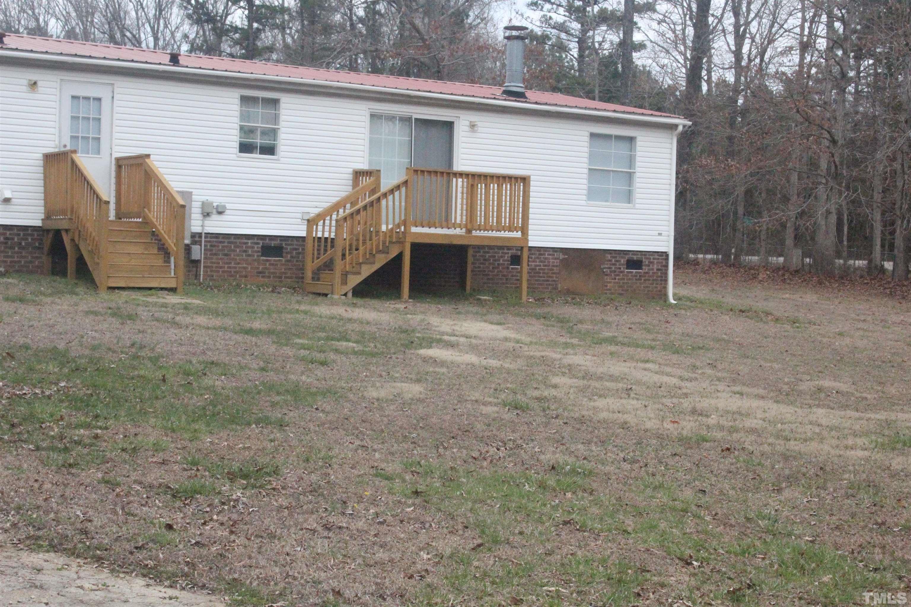 2986 Thomas Road Henderson, NC 27537 - Photo 6 of 21 a view of house with backyard space and balcony