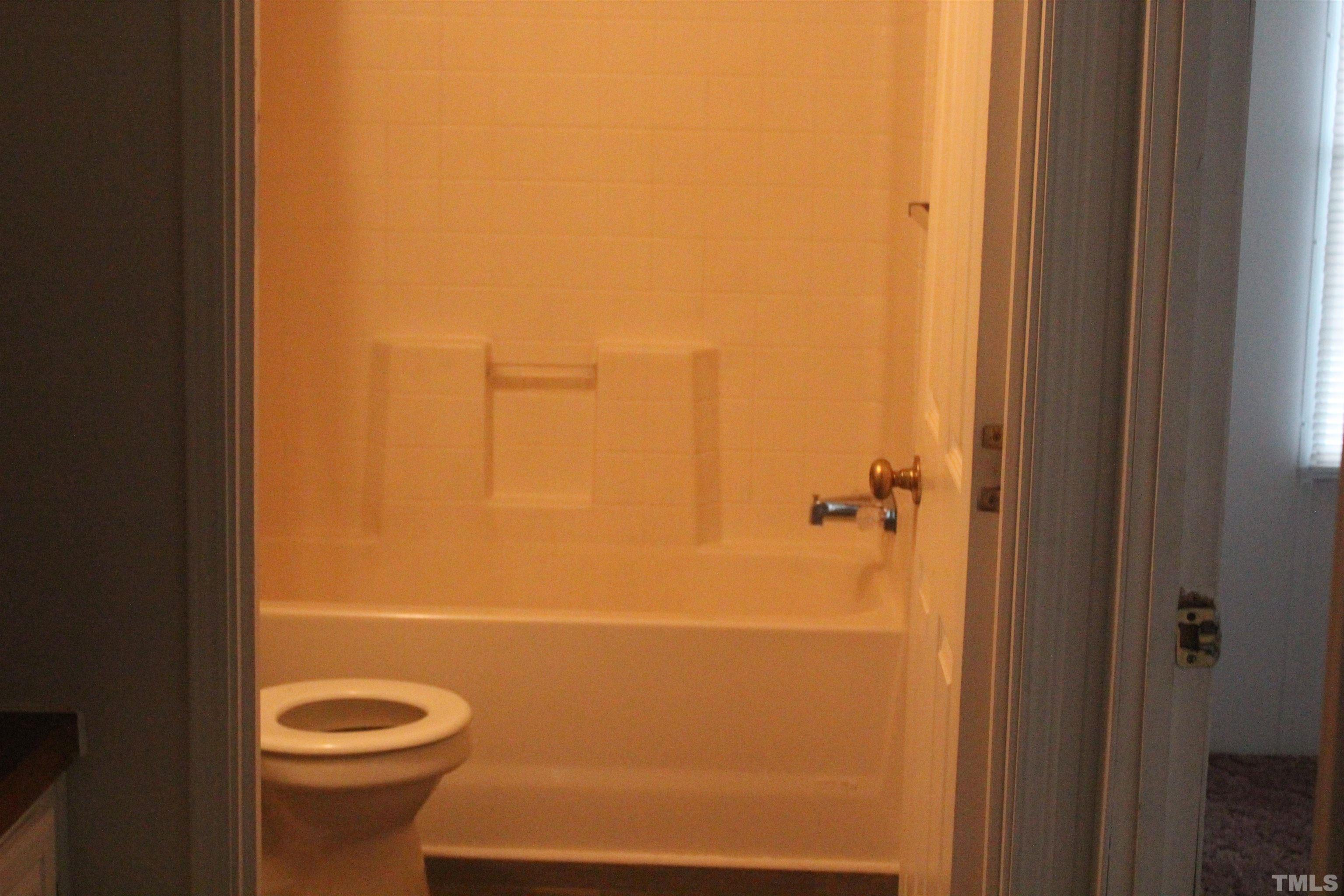 2986 Thomas Road Henderson, NC 27537 - Photo 8 of 21 a bathroom with a granite countertop toilet and a shower