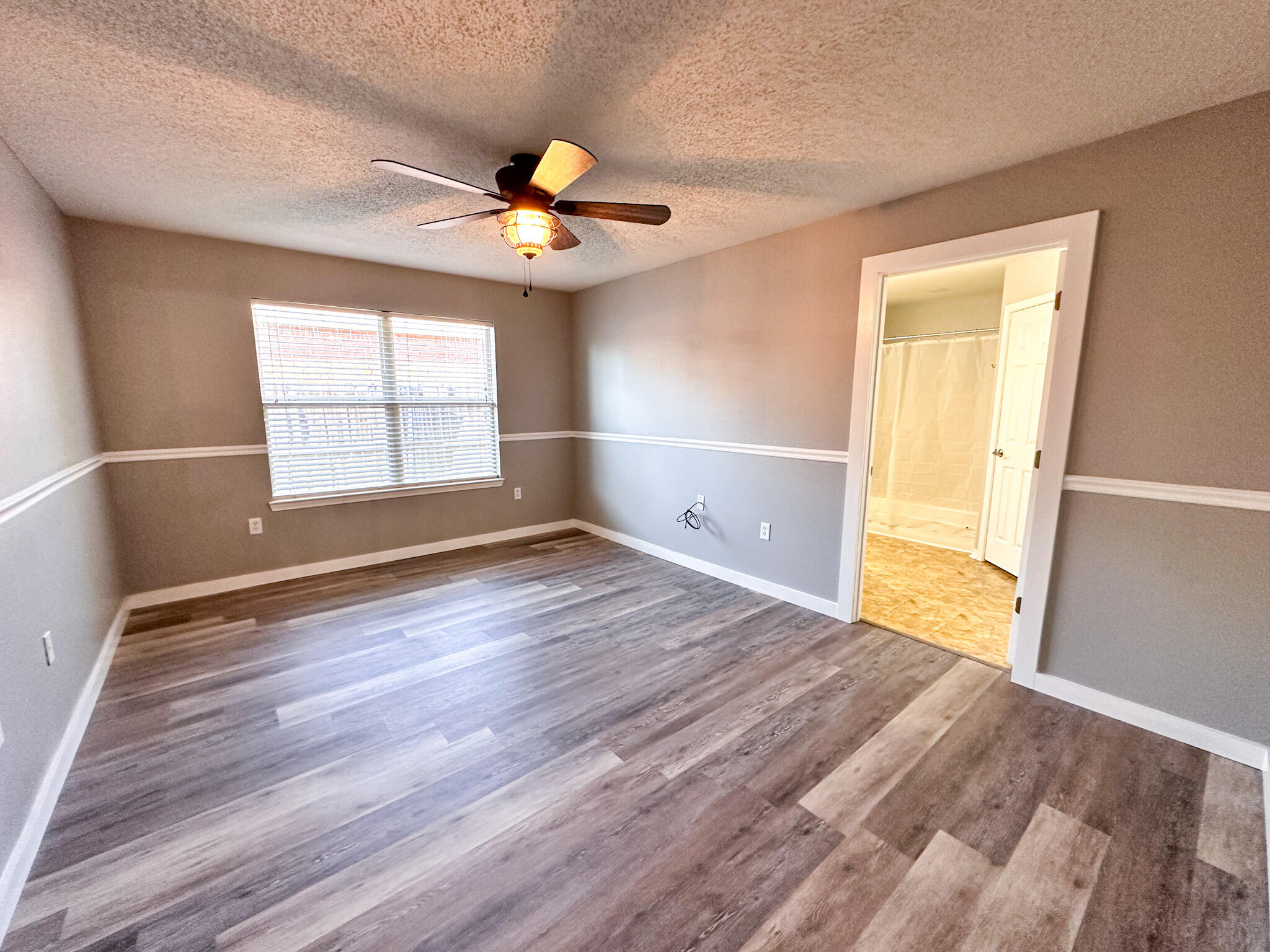 269 Limestone Circle Crestview, FL 32539 - Photo 15 of 32 an empty room with wooden floor and windows