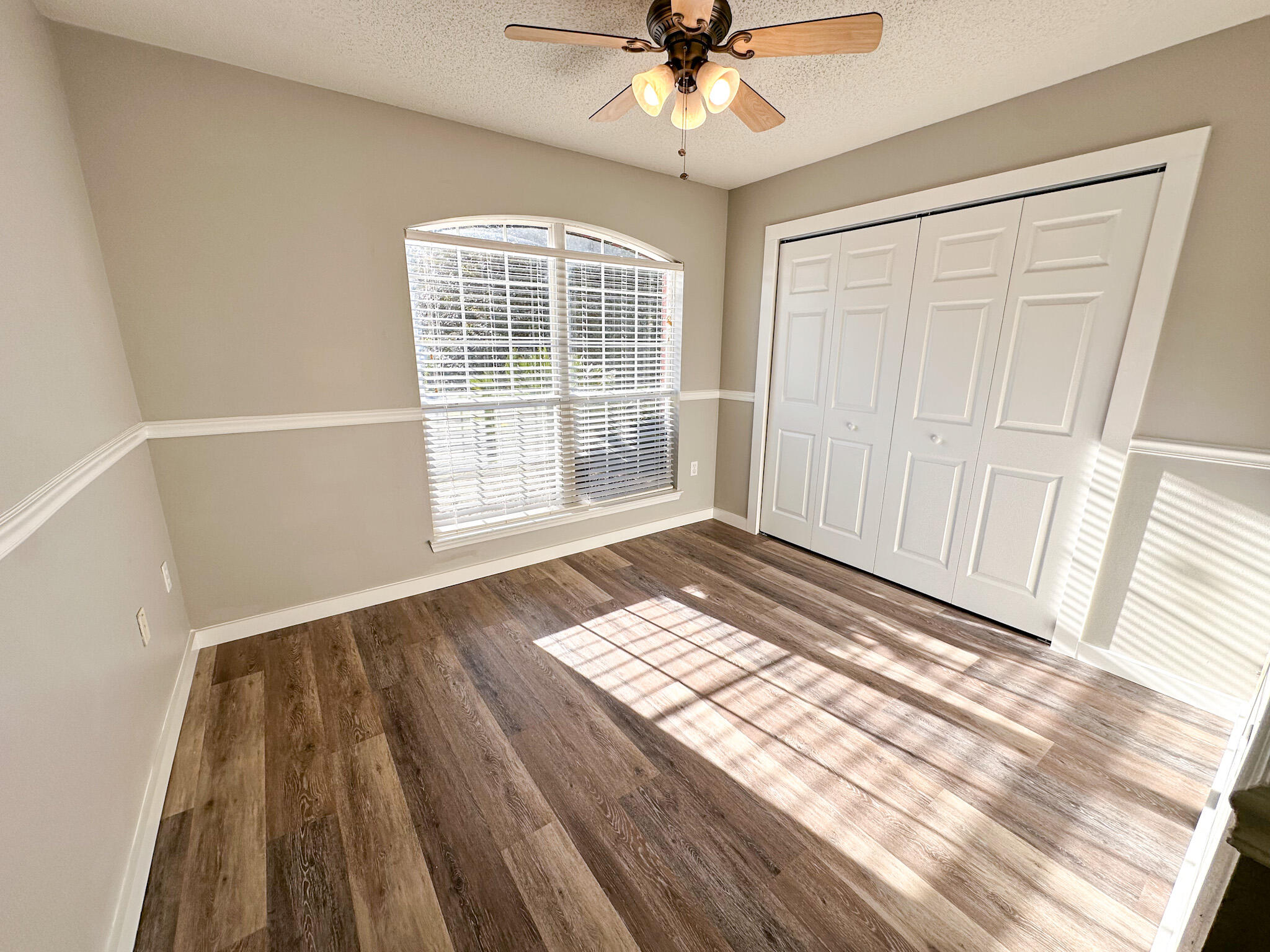 269 Limestone Circle Crestview, FL 32539 - Photo 21 of 32 a view of an empty room with wooden floor and a window