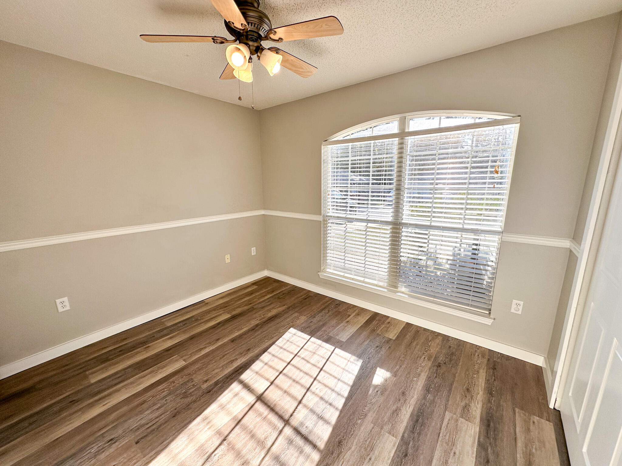 269 Limestone Circle Crestview, FL 32539 - Photo 22 of 32 a view of an empty room with wooden floor and a window