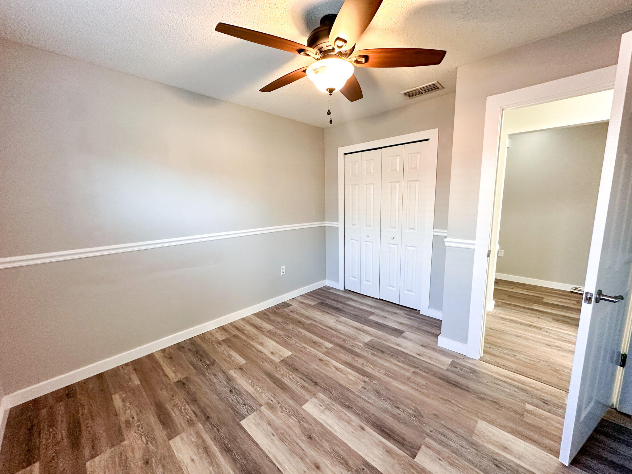 269 Limestone Circle Crestview, FL 32539 - Photo 27 of 32 a view of an empty room with wooden floor