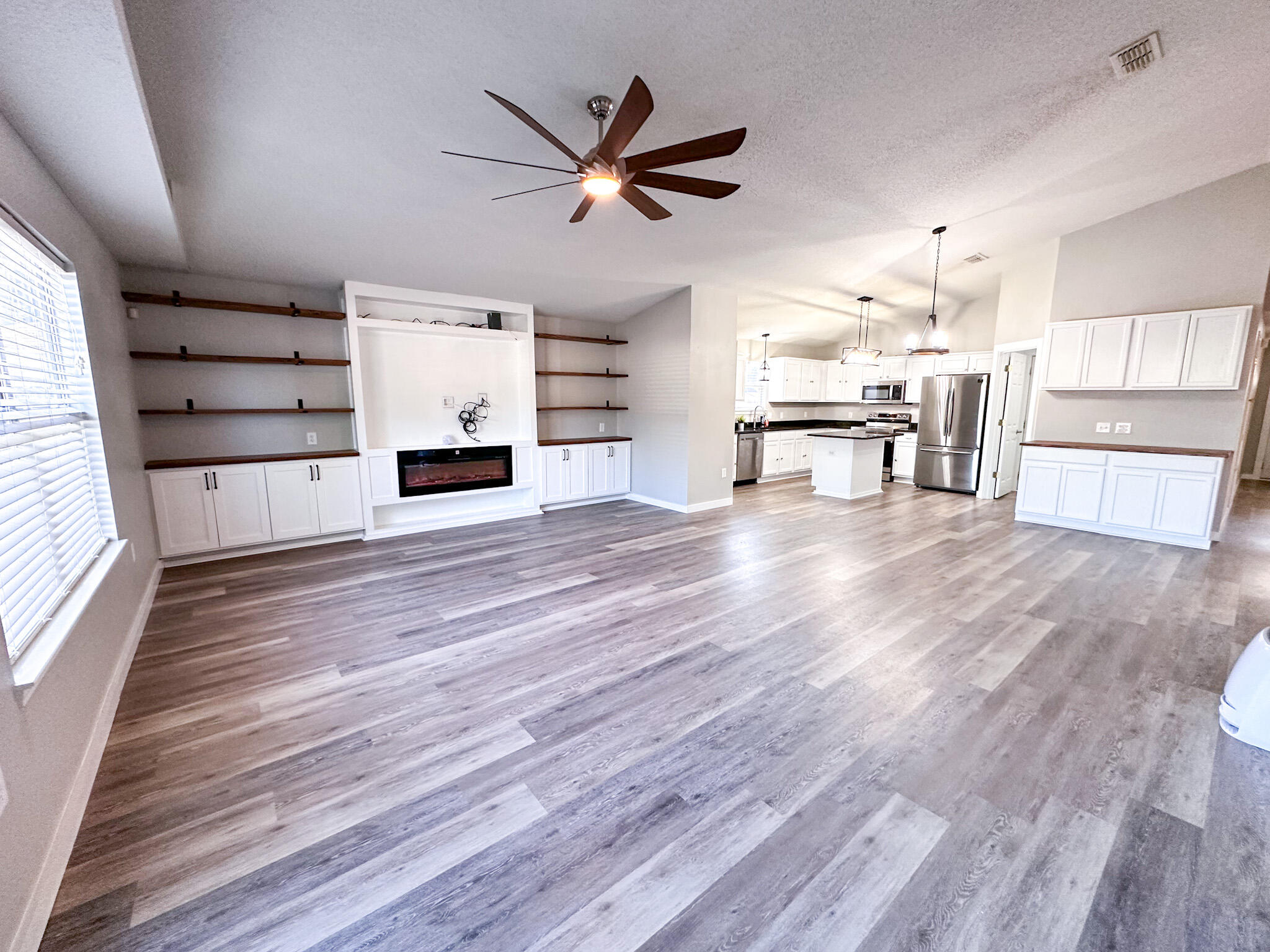 269 Limestone Circle Crestview, FL 32539 - Photo 4 of 32 a view of a livingroom with hardwood floor and a ceiling fan