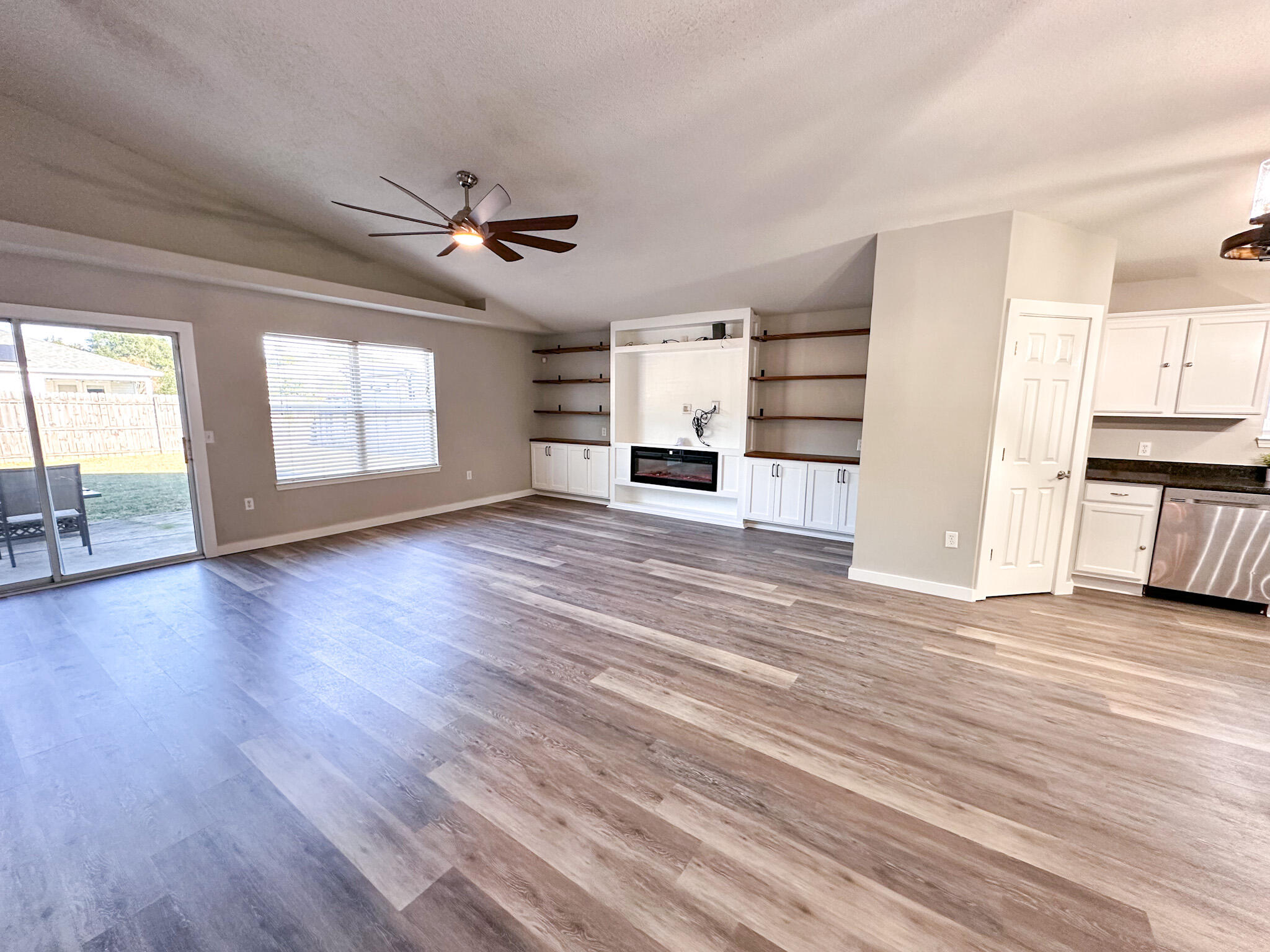 269 Limestone Circle Crestview, FL 32539 - Photo 5 of 32 a view of a kitchen with wooden floor and a ceiling fan