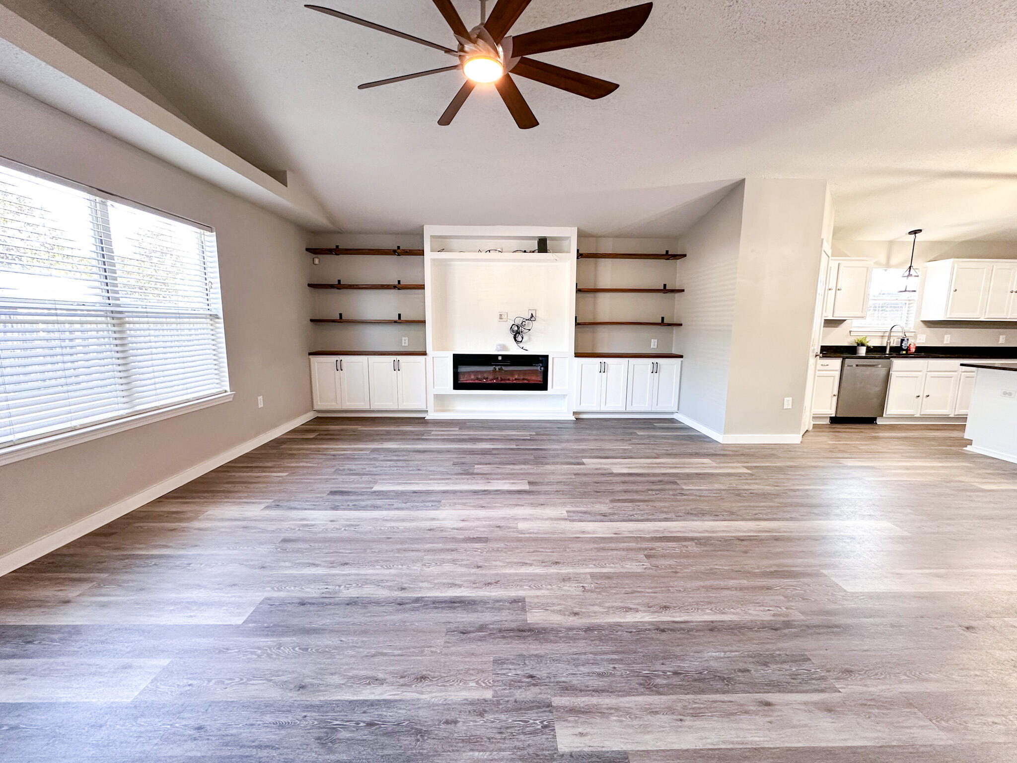269 Limestone Circle Crestview, FL 32539 - Photo 7 of 32 a view of a livingroom with a hardwood floor and a ceiling fan