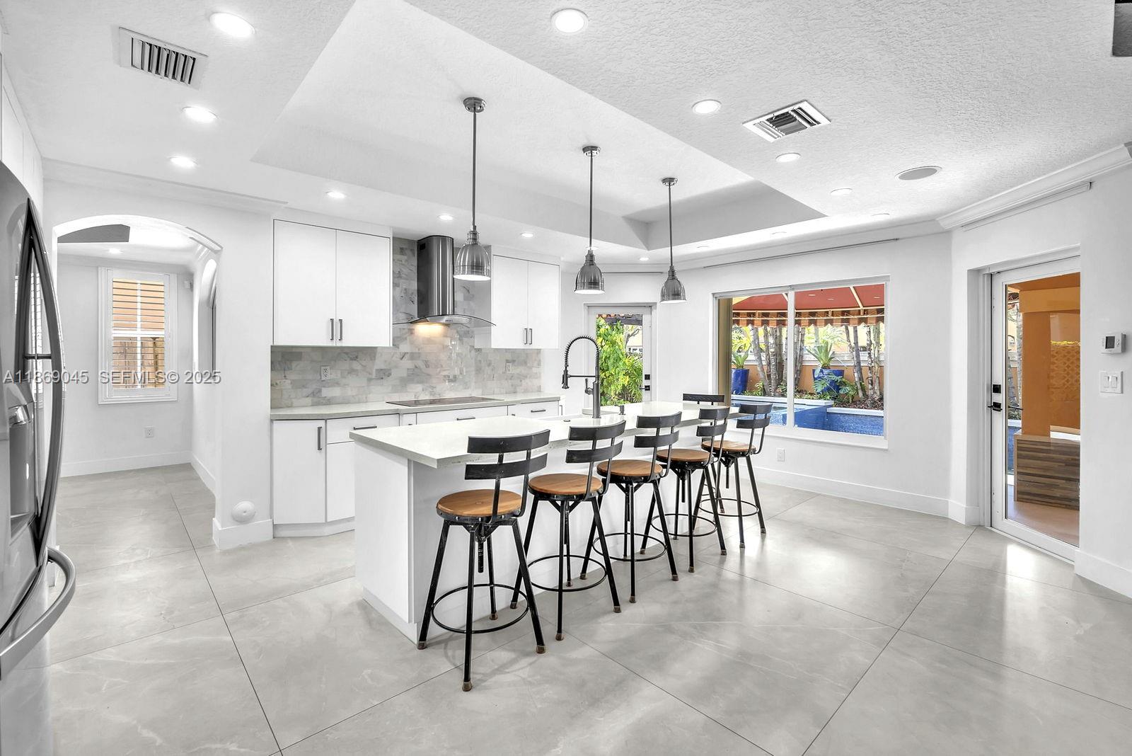 15244 Southwest 29th Terrace Miami, FL 33185 - Photo 15 of 74 a large kitchen with a table and chairs