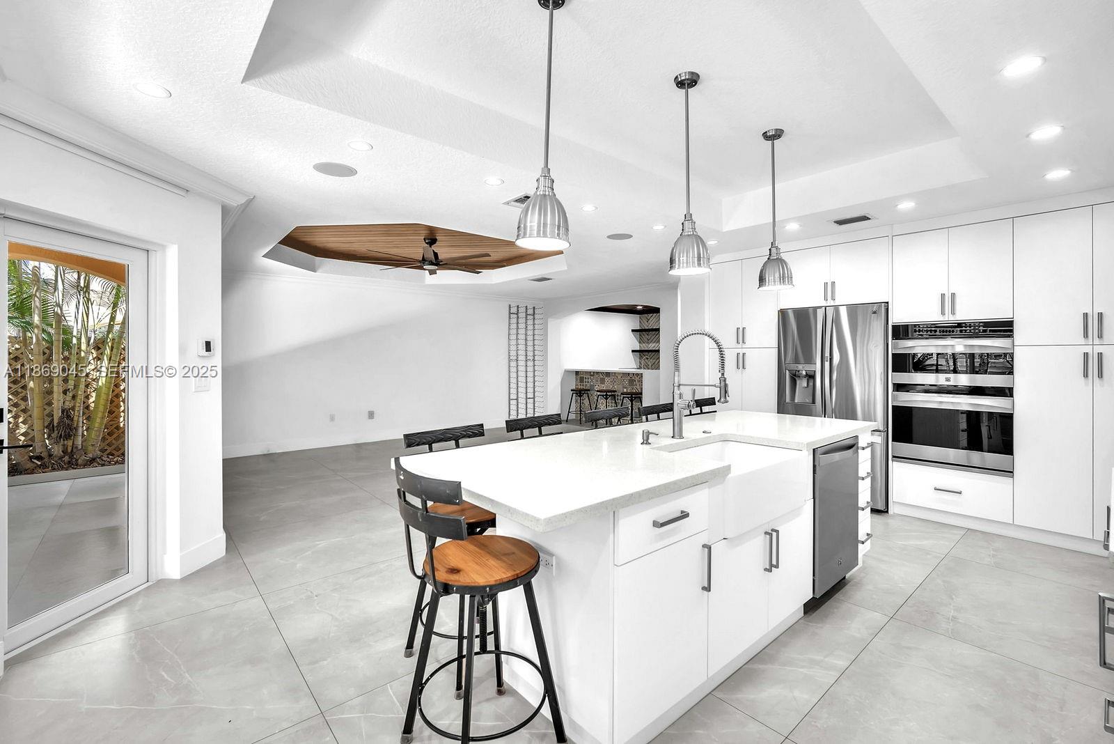 15244 Southwest 29th Terrace Miami, FL 33185 - Photo 19 of 74 a large kitchen with kitchen island a sink stove and a refrigerator