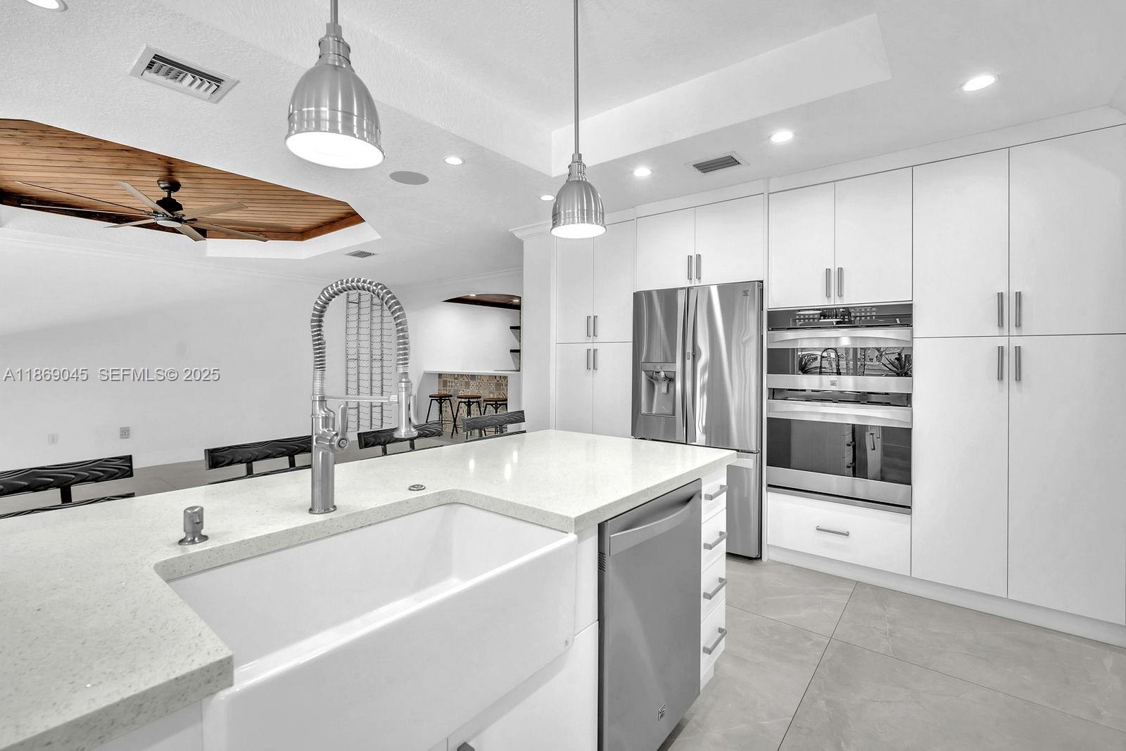 15244 Southwest 29th Terrace Miami, FL 33185 - Photo 21 of 74 a kitchen with stainless steel appliances a refrigerator and a sink