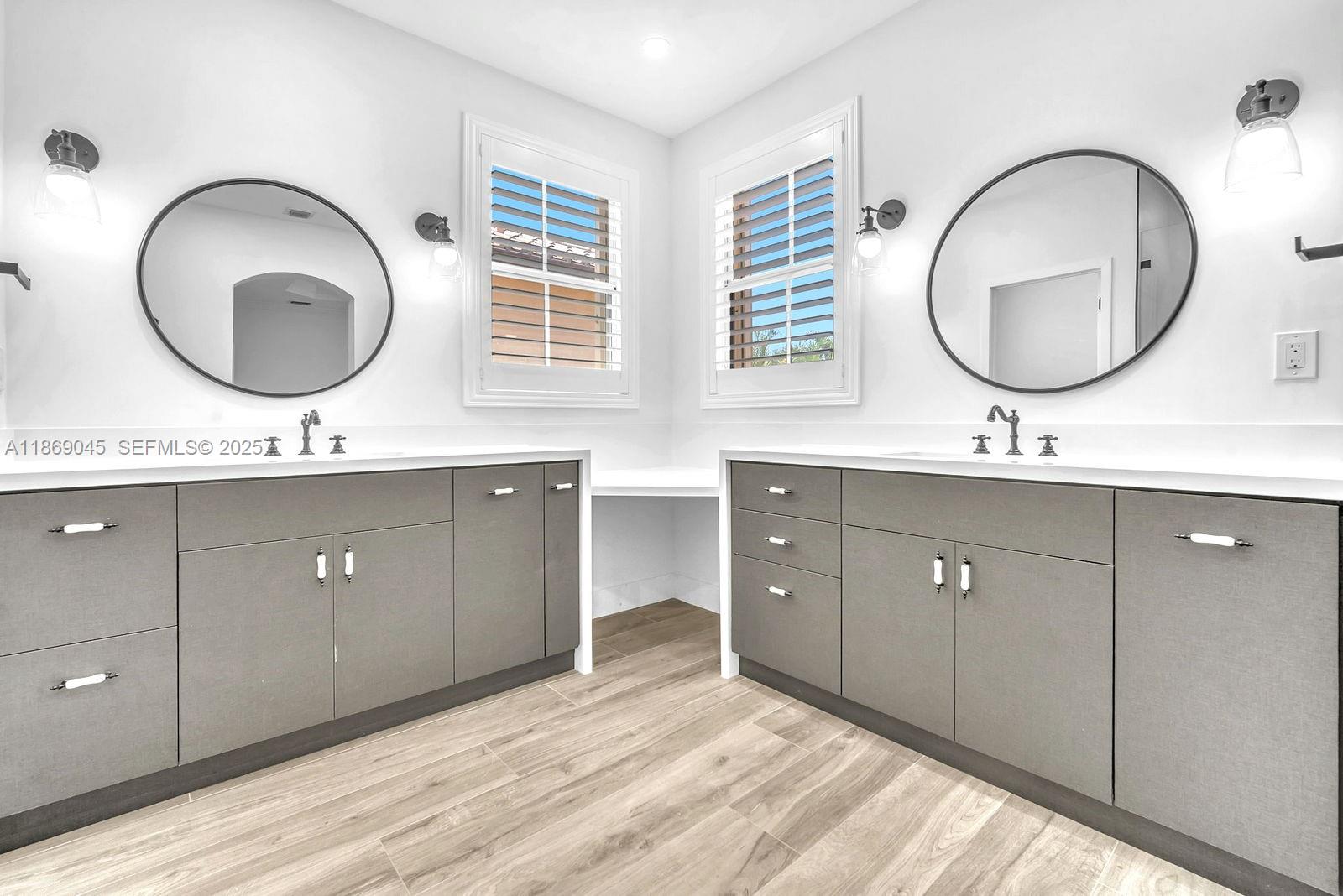 15244 Southwest 29th Terrace Miami, FL 33185 - Photo 31 of 74 a bathroom with a double vanity sink and a mirror