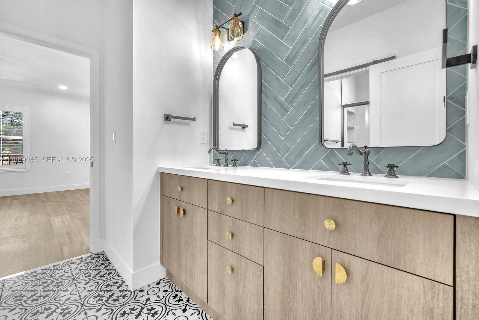 15244 Southwest 29th Terrace Miami, FL 33185 - Photo 38 of 74 a bathroom with a double vanity sink and mirror