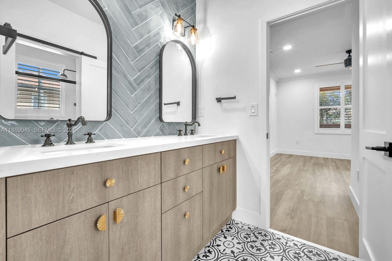 15244 Southwest 29th Terrace Miami, FL 33185 - Photo 39 of 74 a bathroom with a double vanity sink and a mirror