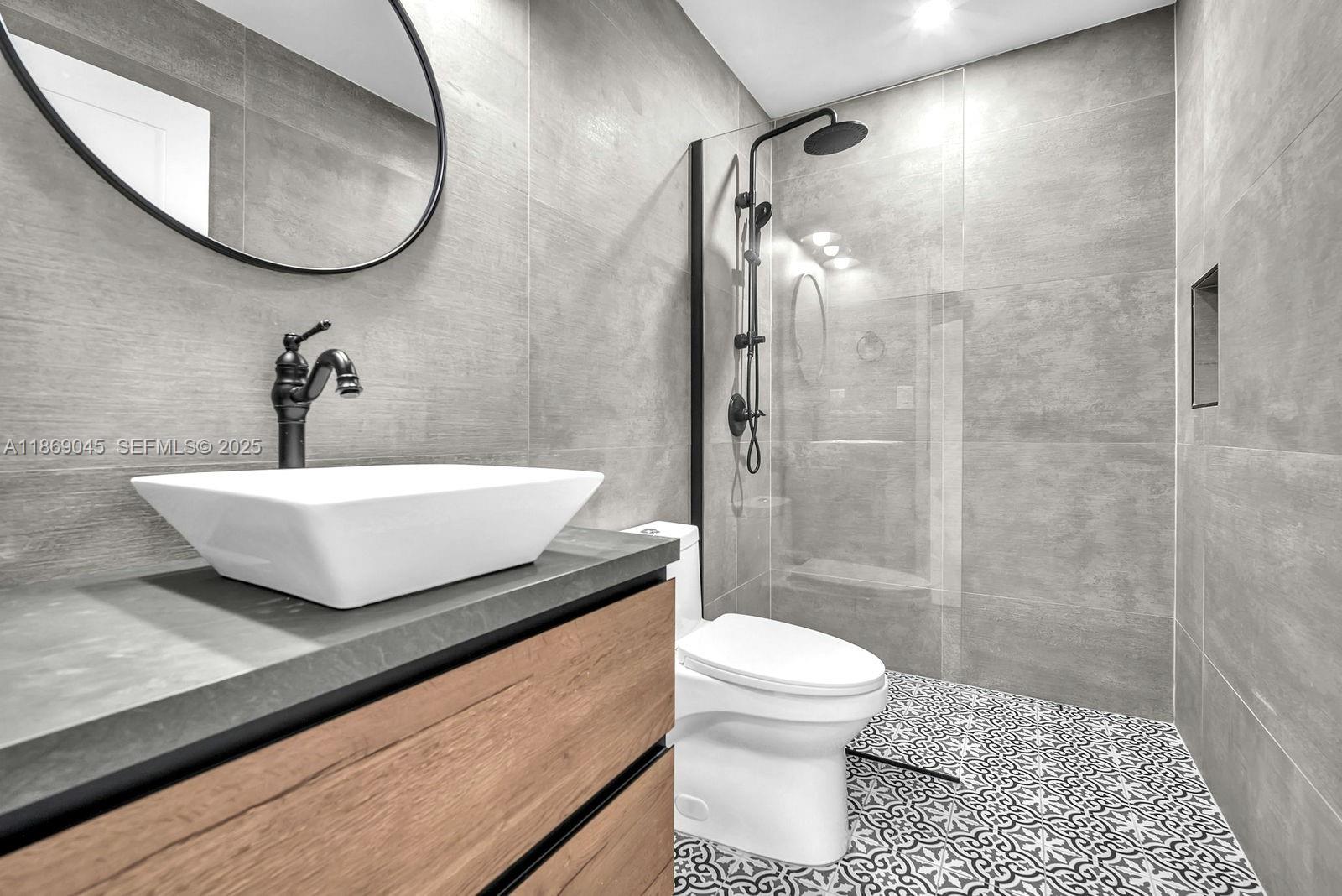 15244 Southwest 29th Terrace Miami, FL 33185 - Photo 40 of 74 a bathroom with a sink a toilet and shower