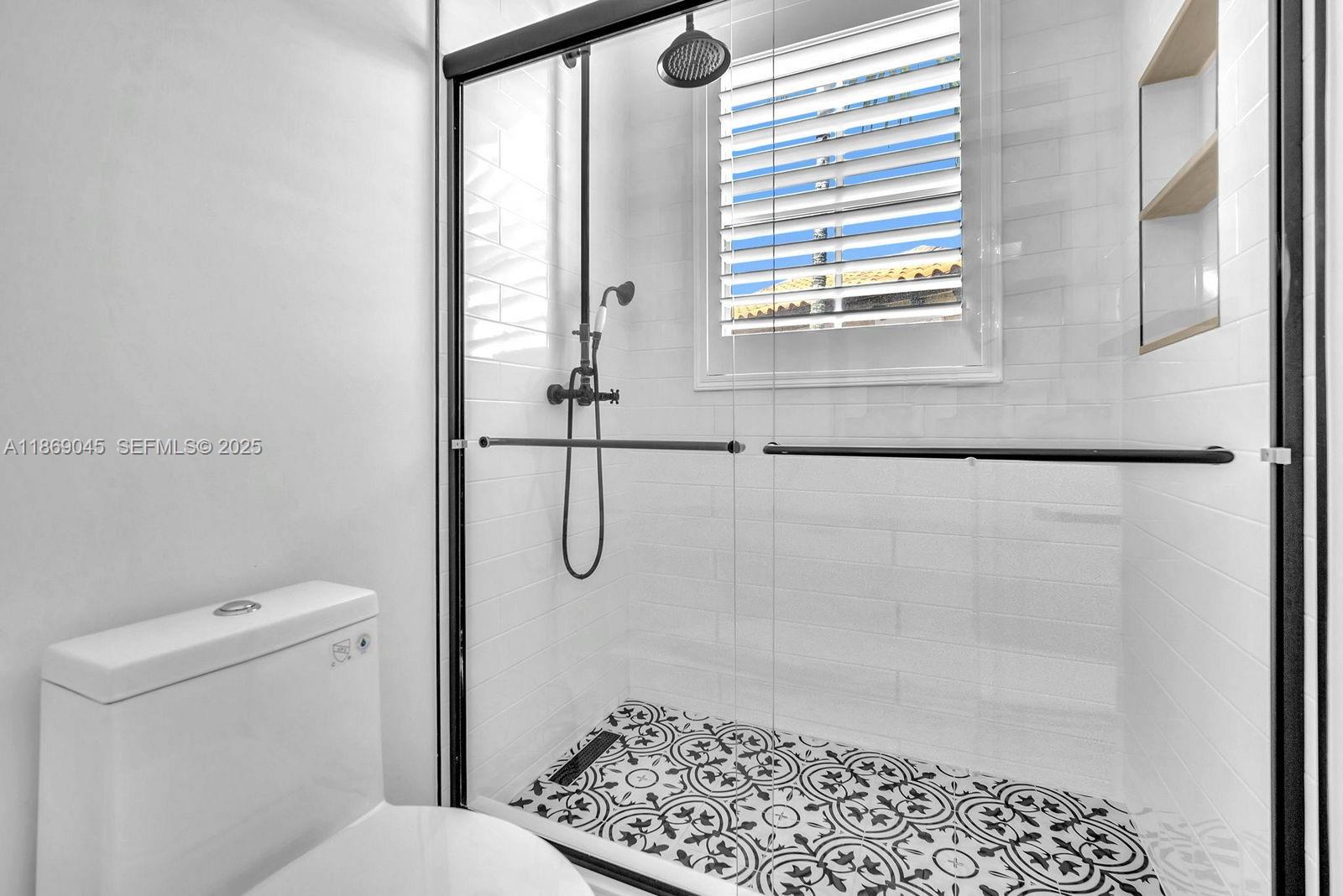 15244 Southwest 29th Terrace Miami, FL 33185 - Photo 41 of 74 a bathroom with a shower a toilet and a window