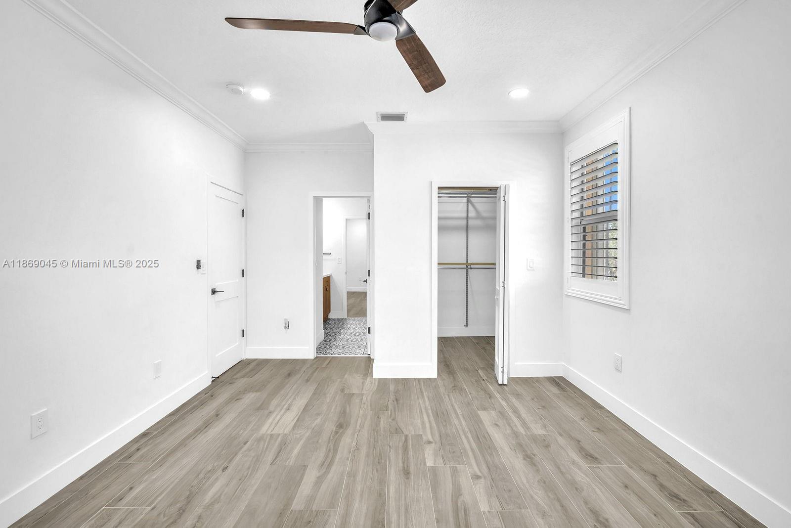 15244 Southwest 29th Terrace Miami, FL 33185 - Photo 43 of 74 a view of empty room with wooden floor and ceiling fan