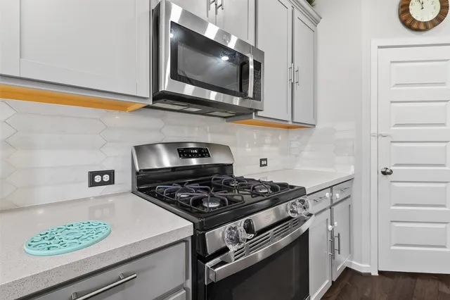 a kitchen with a sink cabinets and wooden floor