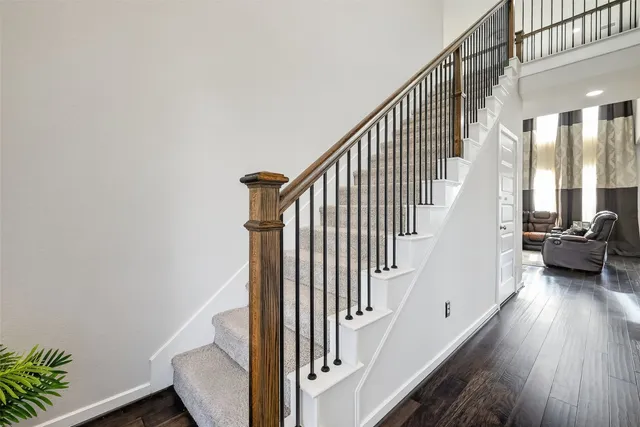 a view of entryway with wooden floor and stairs