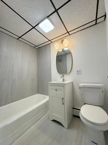 a bathroom with a sink a mirror and a toilet