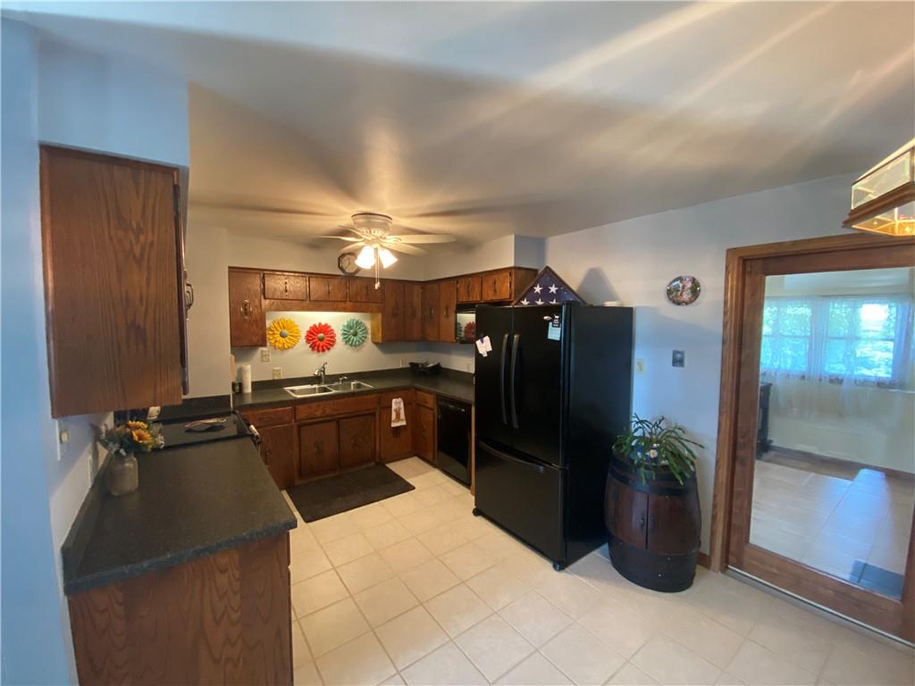 1009 Dutch Ridge Road Ellwood City, PA 16117 - Photo 3 of 12 a kitchen with a refrigerator and a sink