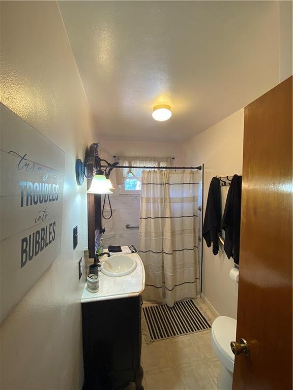 1009 Dutch Ridge Road Ellwood City, PA 16117 - Photo 7 of 12 a bathroom with a sink toilet and shower
