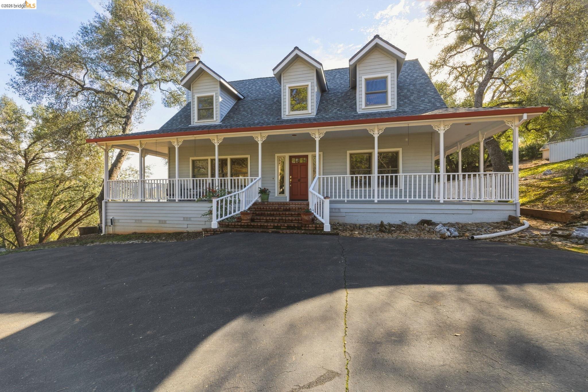 23401 Italian Bar Road Columbia, CA 95310 - Photo 1 of 1 View of front of home featuring a porch and a shingled roof