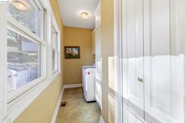 a view of a kitchen with kitchen island a counter top space appliances and cabinets