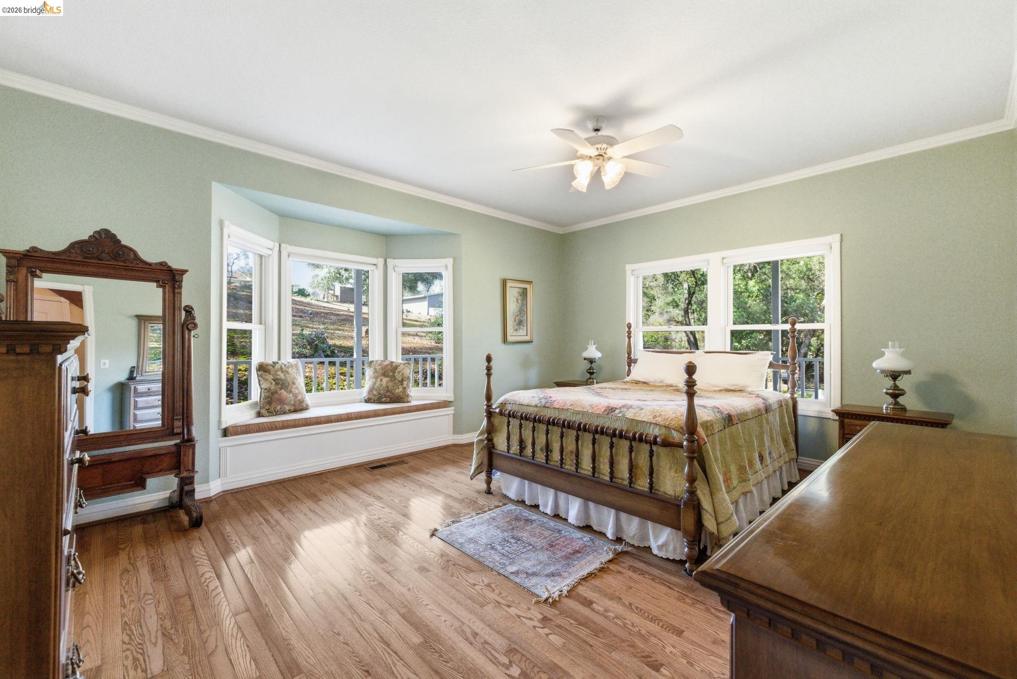 23401 Italian Bar Road Columbia, CA 95310 - Photo 12 of 49 a bedroom with a large bed and a chandelier