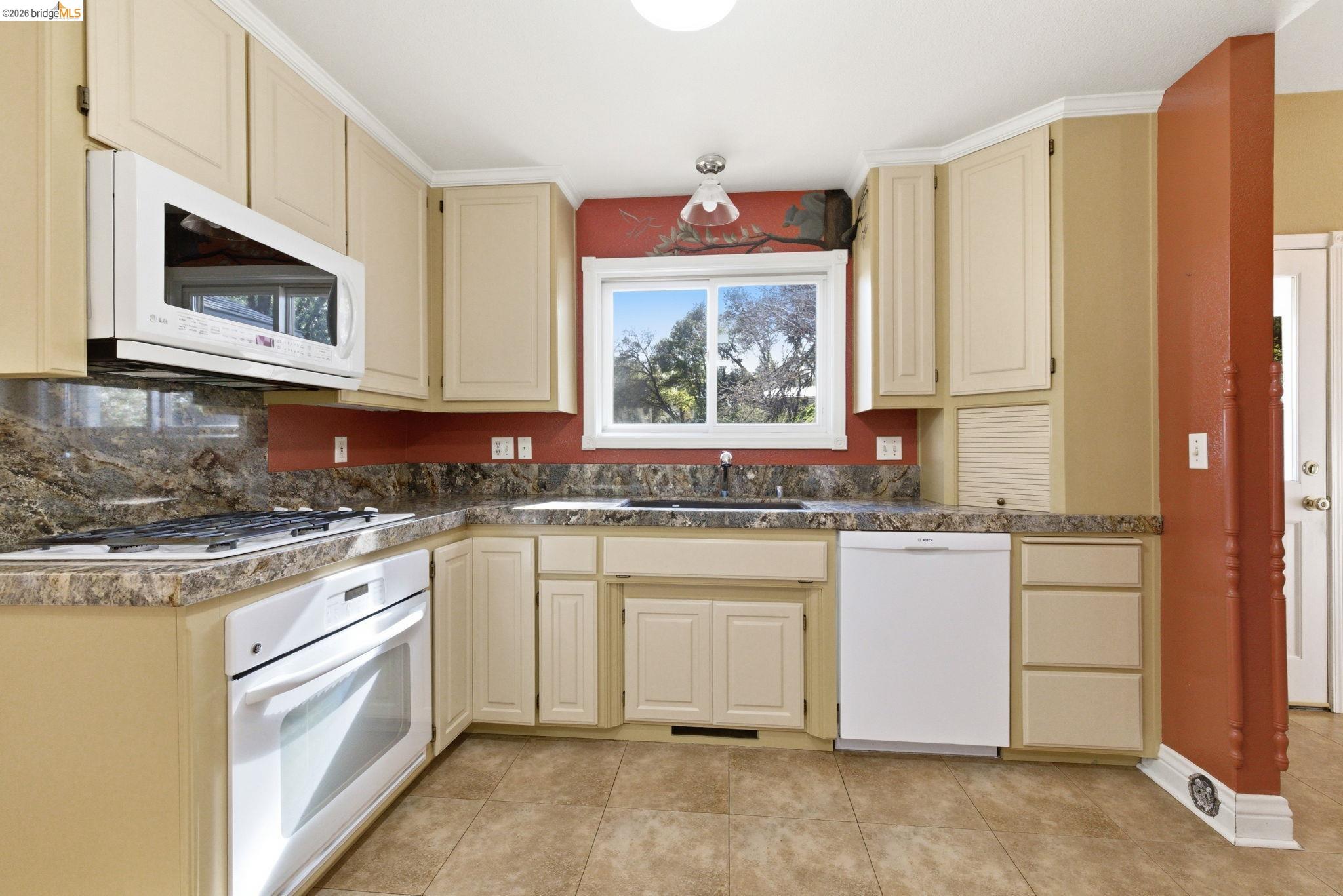 23401 Italian Bar Road Columbia, CA 95310 - Photo 24 of 49 a kitchen with stainless steel appliances granite countertop a stove a sink and a microwave