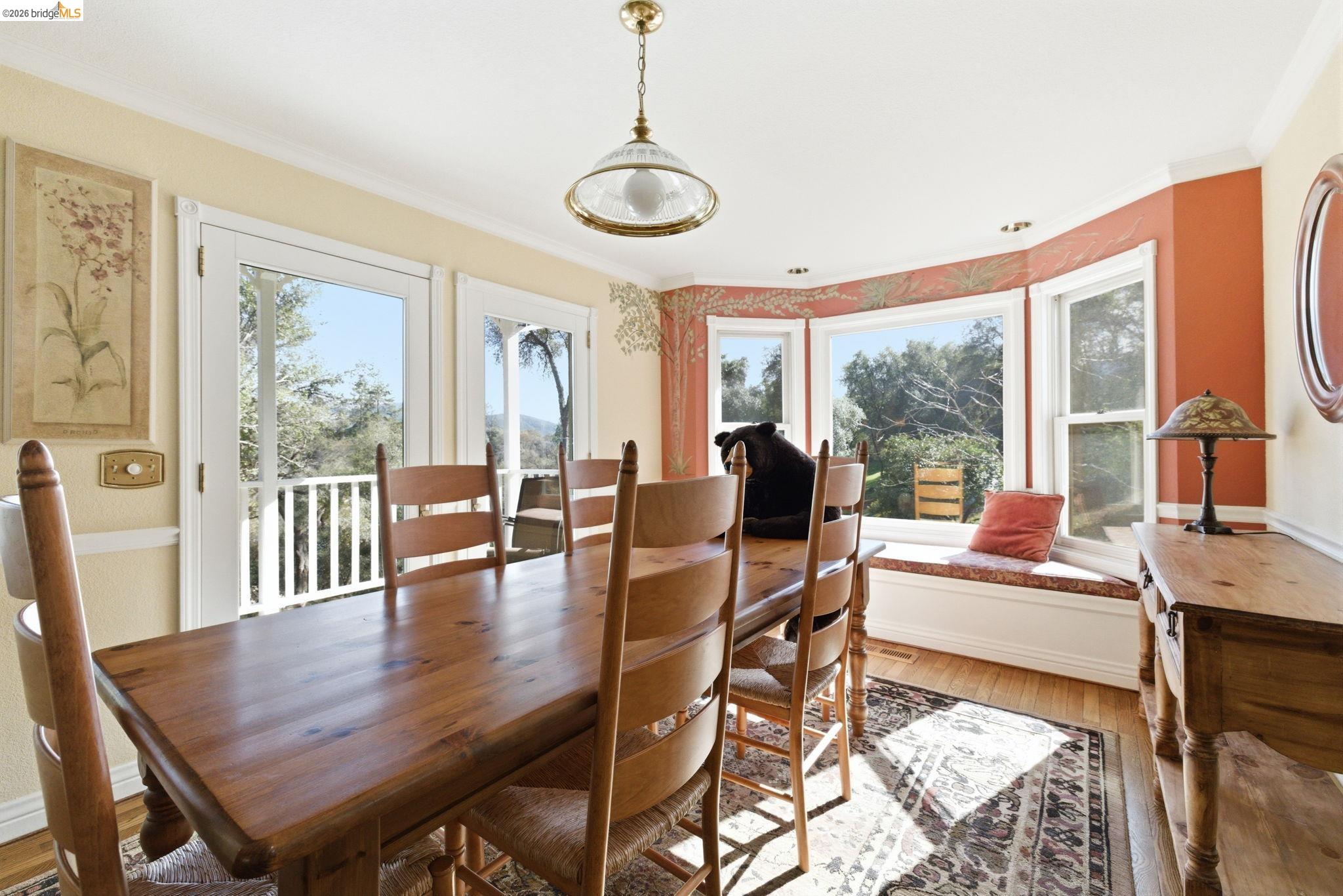 23401 Italian Bar Road Columbia, CA 95310 - Photo 32 of 49 a view of a dining room with furniture window and wooden floor