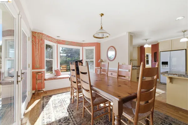 a living room with furniture wooden floor and a floor to ceiling window