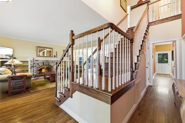 a view of entryway and hall with wooden floor