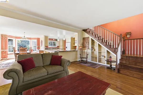 a living room with furniture or stairs and a wooden floor