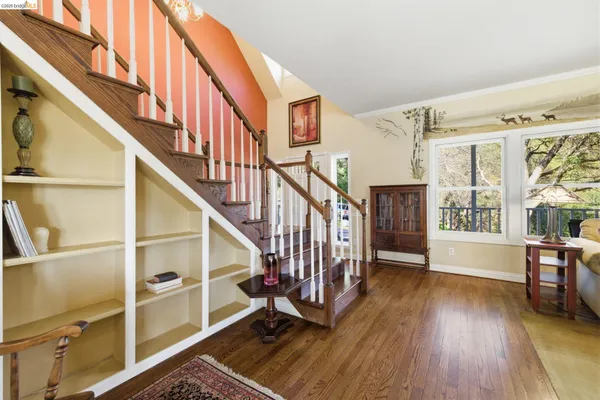 a view of an entryway with wooden floor and windows