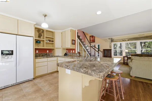 a kitchen with stainless steel appliances granite countertop a sink and cabinets