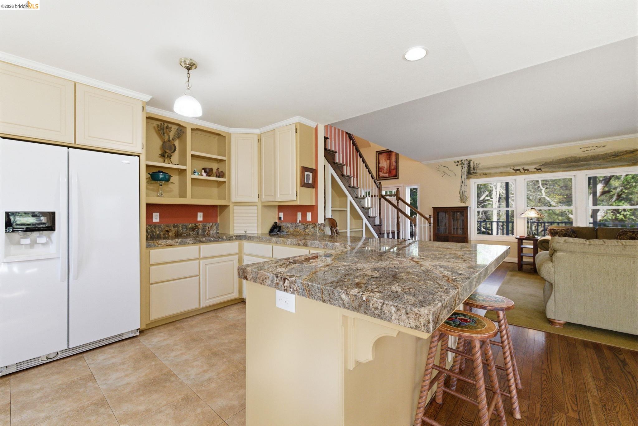 23401 Italian Bar Road Columbia, CA 95310 - Photo 9 of 49 a view of a kitchen with kitchen island a counter top space appliances and cabinets
