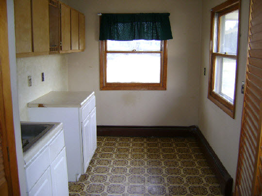 9977 East Flagg Road Rochelle, IL 61068 - Photo 6 of 7 a bathroom with a sink a toilet and a window