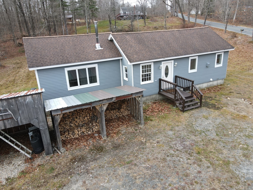 a aerial view of a house with a yard and a swing