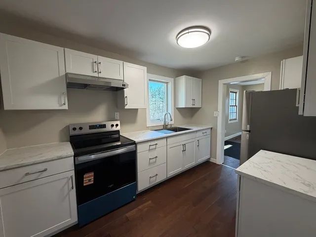 a kitchen with a stove a sink and a refrigerator