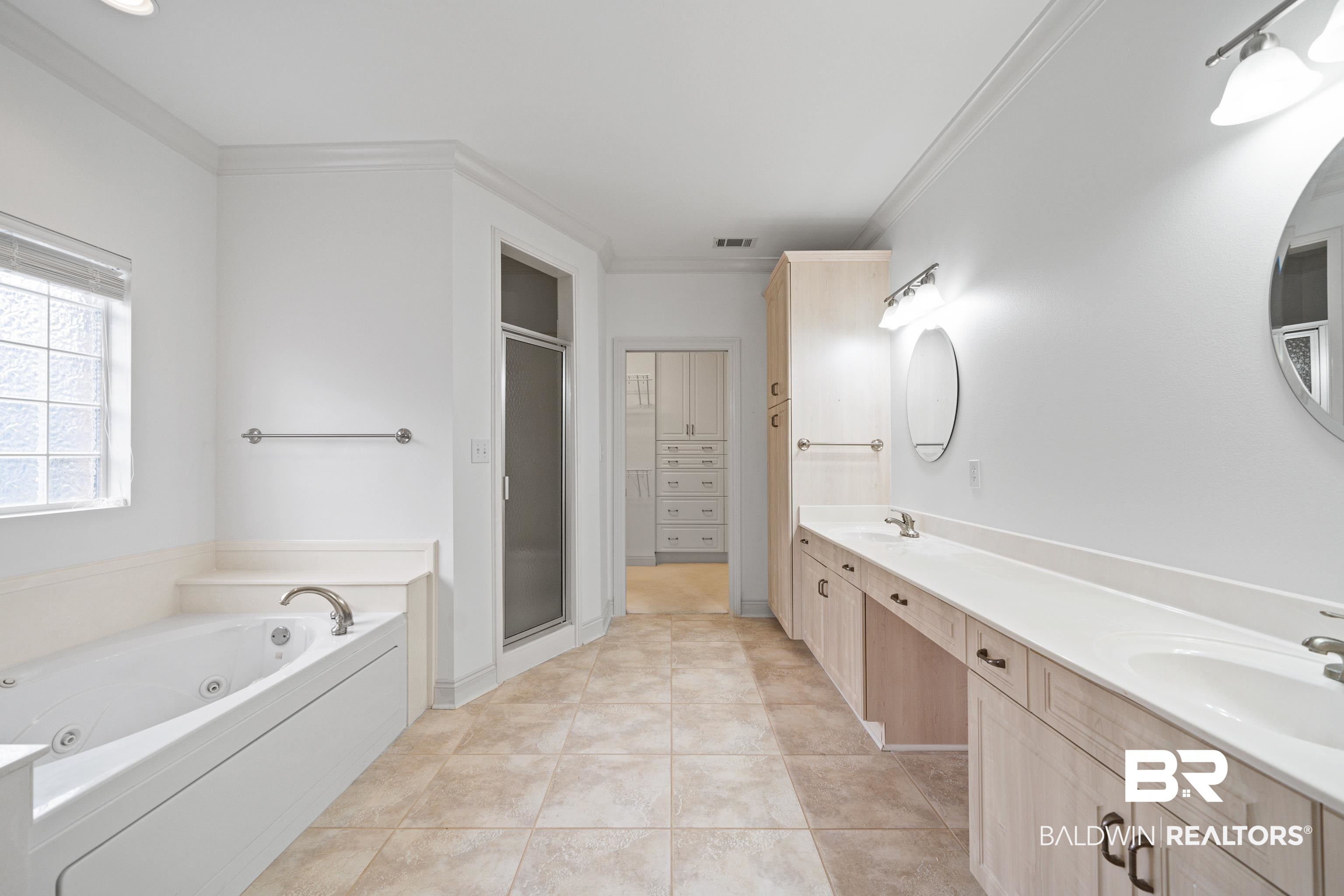 404 Savannah Lane Foley, AL 36535 - Photo 23 of 29 Bathroom with double vanity, crown molding, visible vents, and a sink