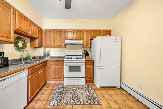 a kitchen with a white cabinets and white appliances