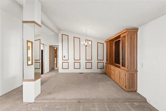a view of a livingroom with entryway wooden floor and cabinet