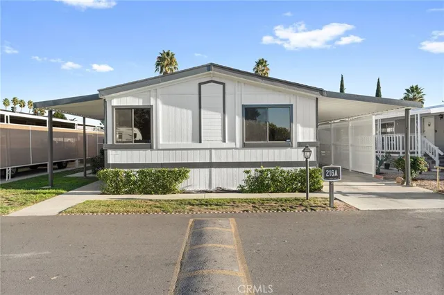a front view of a house with a yard and outdoor seating