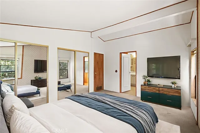 a bedroom with a balcony a bed and a couch